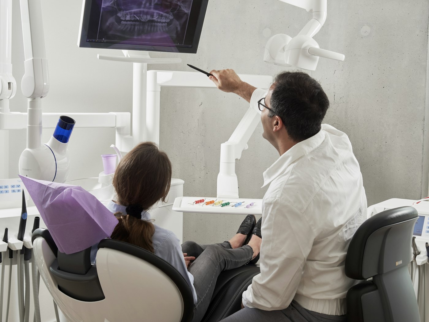 Dentist reviewing a dental image with a patient